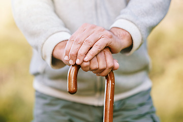 Image showing Hands, elderly and retirement, man with walking stick outdoor for walk with fitness and vitality, disability or old age. Old man with cane for support, active lifestyle and wellness in the park.