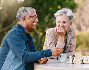 Image showing Happy, chess or couple of friends in nature playing a board game, bonding or talking about a funny story. Park, support or healthy senior people laughing at a joke and enjoying quality relaxing time