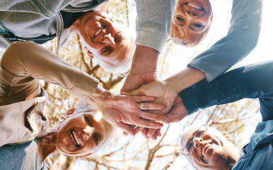 Image showing Team work, hands or group of friends in nature for hiking, trekking or fitness training in nature forest. Senior, low angle or happy elderly people in partnership with support, trust or motivation