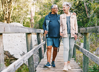 Image showing Relax, senior or couple of friends hiking, walking or trekking for freedom, exercise or fitness in nature forest. Interracial, travel or happy woman enjoys bonding time with healthy elderly partner