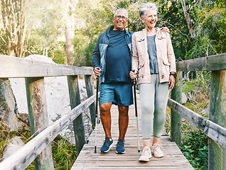 Image showing Relax, senior or couple of friends hiking, walking or trekking for freedom, exercise or fitness in nature forest. Interracial, travel or happy woman enjoys bonding time with healthy elderly partner