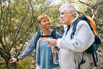 Image showing Relax, senior or couple of friends hiking, walking or trekking for freedom, exercise or fitness in nature forest. Interracial, travel or happy woman enjoys bonding time with healthy elderly partner