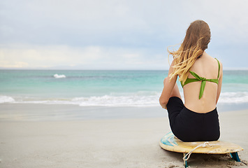 Image showing Beach, fitness or woman with surfboard, freedom or calm peace watching the relaxing ocean waves on holiday vacation. Travel, back view or healthy girl athlete thinking of surfing goals or training