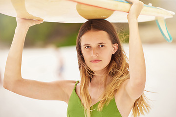 Image showing Woman, portrait and surfer with surfboard at beach, travel and fitness with adventure, exercise and ready to surf in Hawaii. Young girl on holiday, workout and nature with extreme sport and wellness.