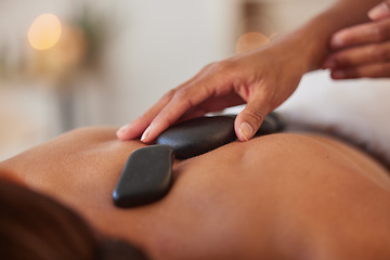 Image showing Massage with stone, hands and therapist in spa for wellness and peace, skincare and cosmetic luxury treatment. Holistic care, masseuse and physical therapy with rocks, back muscle relief and relax.