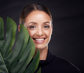 Image showing Beauty, face and skin with leaf and woman with natural cosmetics, green and sustainable skincare against black studio background. Portrait, mockup and nature, tropical organic product and wellness.