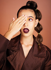 Image showing Surprise, lipstick and makeup with woman and beauty, hand cover eye and mouth, cosmetics and hair care. Fun, wow and lips, cosmetic care and healthy skin, glow and skincare against studio background.