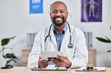 Image showing Happy, smile and portrait of an African doctor sitting in his office after a consultation at the clinic. Healthcare, professional and male medical worker analyzing results in a medicare hospital.