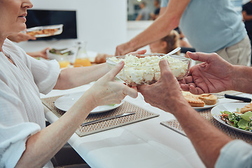 Image showing Hands, lunch and potato salad in family home for healthy food, celebration or people in dining room. Family, dinner and party for food, salad plate or helping hand at table for nutrition to celebrate