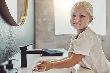 Image showing Bathroom, water and portrait of child washing hands with soap, foam and healthy hygiene. Cleaning dirt, germs and bacteria on fingers, happy girl in home for morning wellness, safety and skin care.