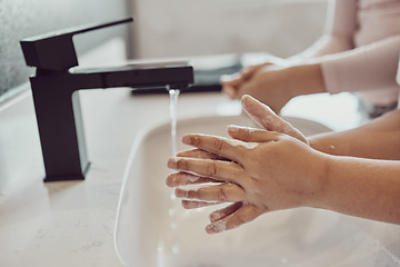 Image showing Bathroom, water and children cleaning hands with soap, foam or learning healthy hygiene together. Washing dirt, germs or bacteria on fingers, kids in home in morning for wellness, safety or skin care