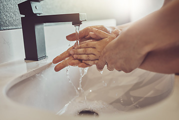 Image showing Bathroom, water and parent with child washing hands with soap, foam or learning healthy hygiene together. Washing dirt, germs or bacteria, person and kid in home in morning with help, care or support