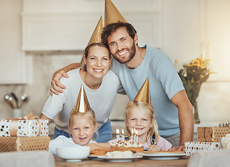 Image showing Portrait of parents, girl children and birthday cake for celebration with candles, love and sweets in home. Happiness, face of mother and father together at table at happy kids party event in house.