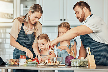 Image showing Happy family in kitchen, cooking together with kids and teaching, learning and nutrition with parents. Mom, dad and girl children help making healthy food in home with care, support and love at lunch
