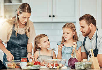 Image showing Happy family in kitchen, cooking together with children and teaching, learning and nutrition with parents. Mom, dad and girl kids help making healthy food in home with care, support and love at lunch