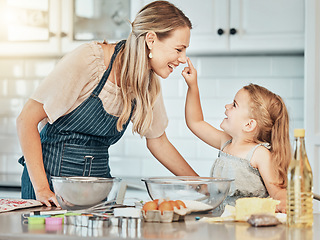 Image showing Happy mother in kitchen, bake together with child and flour, playing and learning with woman. Love, mom and girl kid with help baking cookies in home with care, support and teaching at playful lunch.