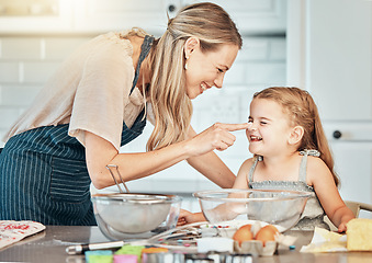 Image showing Playful mother in kitchen, baking with kid and cooking fun, learning and nutrition with happy woman. Cookies, mom and girl children helping bake breakfast together in home with care, support and love