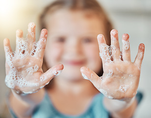Image showing Soap, washing hands and kid with foam for cleaning, hygiene and wellness in bathroom at home. Health, child development and palms of young girl with water for protection for germs, virus and bacteria