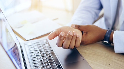 Image showing Person, laptop and hands with wrist pain, injury or carpal tunnel syndrome by office desk. Closeup of business employee with sore muscle, ache or joint inflammation from arthritis or strain on table