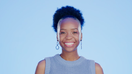 Image showing Smile, happy and portrait of black woman in a studio with positive, confident and good attitude. Excited, pride and young African female model with joy and happiness isolated by blue background.