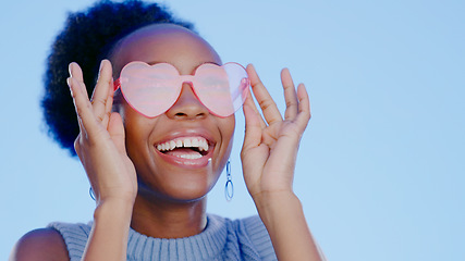 Image showing Fashion, sunglasses and smile, black woman in studio with cool, trendy summer style and creative mockup. Happiness, luxury eyewear and excited, fun model with designer frame on blue background space