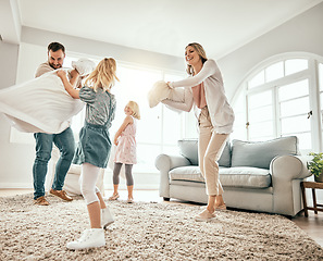 Image showing Happy family, pillow fight and playing in living room together for fun holiday, weekend or bonding at home. Mother, father and children smile with cushion game, play or free time for summer break