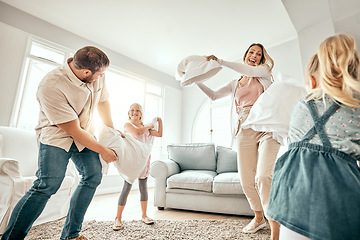 Image showing Happy family, pillow fight and playing in living room for bonding, fun holiday or weekend together at home. Mother, father and children smile with cushion game, play or free time for summer break