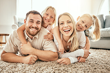 Image showing Happy, smile and portrait of family in the living room bonding, hugging and relaxing together. Happiness, love and girl children laying with parents from Australia on floor in lounge at modern home.