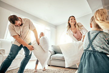 Image showing Happy family, pillow fight and playing in living room for fun bonding, holiday or weekend together at home. Mother, father and children smile with cushion game, play or free time for summer break