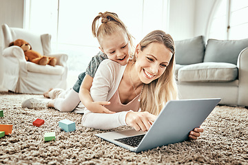 Image showing Mother, girl and laptop for home games, e learning and funny video streaming or education on carpet in living room. Excited mom, family and child play on floor on computer, kids website or internet