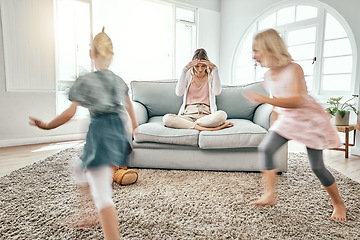 Image showing Mother, children and running in living room chaos with headache in stress on sofa at crazy or busy home. Frustrated single parent in burnout with ADHD or hyperactive kids or siblings playing in house