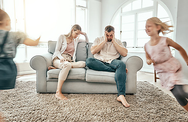 Image showing Frustrated couple, children and running in living room chaos with headache in stress on sofa at crazy or busy home. Parents in burnout with ADHD or hyper active kids or siblings playing wild in house