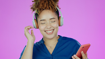 Image showing Headphones, music and woman with phone in studio listening to song, audio and radio. Happy, smile and face of person with smartphone for streaming subscription, relax and fun on purple background