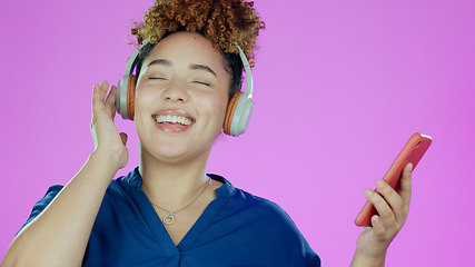 Image showing Headphones, dance and woman with phone in studio listening to song, audio and radio. Happy, music and face of person with smartphone for streaming subscription, relax and fun on purple background