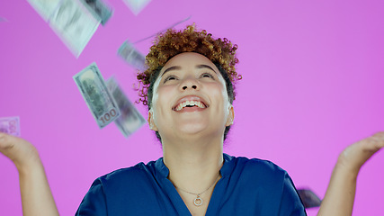 Image showing Woman, winner and money rain and success, bonus or winning of lottery prize, profit or cashback in studio. Happy african person with cash in air, financial freedom and celebration a pink background