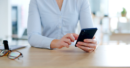 Image showing Phone, hands typing at desk and closeup on social media, networking or writing email in office. Business woman on mobile app at table, digital communication and consultant scroll for internet search