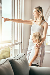 Image showing Window, pointing and mother with girl in home looking outdoors for bonding, relationship and relax. Happy family, house and mom with child in living room for scenic view on weekend, morning and fun