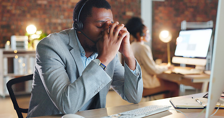 Image showing African man, call center and stress by computer, tired or mistake for tech support, glitch or error. Consultant, crm or agent in night, telemarketing or customer service with fatigue, burnout or fail