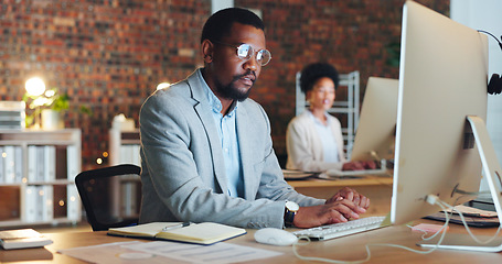 Image showing Business man, office and computer for night planning, typing financial report and online research in accounting. Professional african accountant on desktop for email or analysis in startup workspace