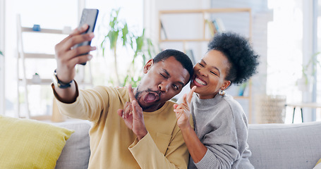 Image showing African couple, selfie and sofa with peace sign, smile or funny face on blog, love or bonding in home. Black woman, man and photography for memory, profile picture or comic social media post in house