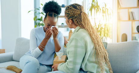 Image showing Sad, empathy and support with black woman friends on a sofa in the living room of a home together. Depression, mental health and a young person crying into a tissue during loss, pain or grief