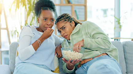 Image showing Scary, movie and friends on sofa in living room with popcorn, snack or delicious in house. Black woman, people and together by watching tv, horror or film with expression on face by sitting on couch