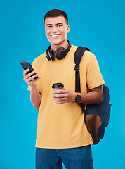 Image showing Student, man and smile with phone, studio and portrait with coffee by blue background. Asian male, ready and portrait for university, scholarship and education, smartphone and online registration