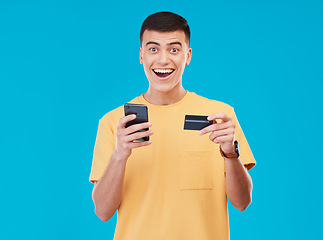 Image showing Credit card, portrait and man with a cellphone, payment and transaction with savings on a blue background. Person, ecommerce and model with a smartphone, digital app and online banking with finance