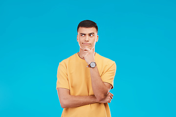 Image showing Thinking, idea and young man in studio with decision, brainstorming or solution expression. Problem solving, planning and male model from Canada with reflection, memory or question by blue background