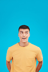 Image showing Man, face and thinking of idea with wow expression, surprised or open mouth in studio on blue background. Fashion, emoji and person on mock up space for deal, sale or discount announcement or news