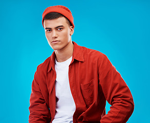 Image showing Serious, fashion and portrait of man on a blue background for stylish, trendy or cool clothes. Outfit, shirt and a person or male model in clothing for a casual aesthetic with confidence on backdrop