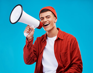 Image showing Portrait, megaphone and man with a smile, equality and promotion with a speech on a blue background. Person, activist and model with a bullhorn, change and happiness with freedom and mockup space