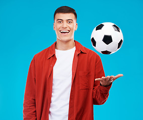 Image showing Man, portrait and soccer ball for sports game in studio, active athlete or fan with fitness isolated on blue background. Happiness, football and training for match with competition and supporter