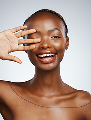 Image showing Portrait of happy black woman, hand or natural beauty for wellness in studio with shine or glow. Dermatology, clean face or proud African girl model with smile or skincare results on white background